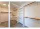 Bright walk-in closet with carpet, extensive shelving and wooden clothes-hanging rods at 3837 E Windsong Dr, Phoenix, AZ 85048