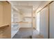 Bright walk-in closet with carpet, extensive shelving and wooden clothes-hanging rods at 3837 E Windsong Dr, Phoenix, AZ 85048
