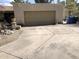 Long driveway leading to a two-car garage, with mature landscaping and desert details at 401 W Cape Royal Ln, Phoenix, AZ 85023