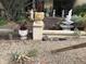 Front yard features rock and gravel desert landscaping with cacti, pottery, and stone statues at 401 W Cape Royal Ln, Phoenix, AZ 85023