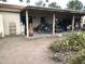 Spacious covered patio has a textured concrete floor and an outdoor seating area with wrought iron furniture at 401 W Cape Royal Ln, Phoenix, AZ 85023