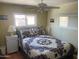 Cozy bedroom featuring a large bed with classic quilt and natural light at 4065 E University Dr # 155, Mesa, AZ 85205