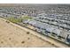 Expansive aerial view of a Primary-planned community with single-Gathering homes and neighborhood park at 40848 W Hillman Dr, Maricopa, AZ 85138