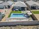 Aerial view of a backyard featuring a pool, hot tub, and patio area, surrounded by privacy walls at 40848 W Hillman Dr, Maricopa, AZ 85138