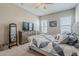 Spacious bedroom with neutral walls, carpeted floors, and a decorative quilt on the plush bed at 40848 W Hillman Dr, Maricopa, AZ 85138