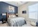Stylish bedroom featuring an accent wall, cozy bed, and modern decor at 40848 W Hillman Dr, Maricopa, AZ 85138