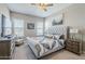 Inviting bedroom featuring a tufted headboard, neutral walls, and carpeted floors for comfort at 40848 W Hillman Dr, Maricopa, AZ 85138