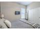 Bedroom with neutral colors, comfortable bed and TV with large windows providing lots of light at 40848 W Hillman Dr, Maricopa, AZ 85138