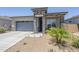 Charming single-story home with stone accents, low-maintenance landscaping, and a convenient two-car garage at 40848 W Hillman Dr, Maricopa, AZ 85138