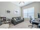 Comfortable office with large window, desk and sofa and a book shelf at 40848 W Hillman Dr, Maricopa, AZ 85138