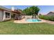 Spacious backyard with lush green grass, a sparkling pool, and inviting patio area at 4313 E Briarwood Ter, Phoenix, AZ 85048
