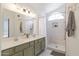 Bright main bathroom featuring double sinks, modern fixtures, and a walk-in shower at 4313 E Briarwood Ter, Phoenix, AZ 85048