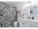 Stylish bathroom featuring a modern vanity, circular mirror, and patterned shower curtain at 4313 E Briarwood Ter, Phoenix, AZ 85048