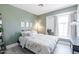 Serene bedroom with soft green walls, neutral decor, and a cozy window nook at 4313 E Briarwood Ter, Phoenix, AZ 85048
