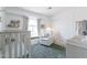 Bright Bedroom with window seat, glider, modern crib, and ample natural light at 4313 E Briarwood Ter, Phoenix, AZ 85048