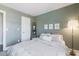 Relaxing bedroom featuring soft green walls, light wood floors and large window at 4313 E Briarwood Ter, Phoenix, AZ 85048