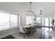 Bright dining room with large windows and modern light fixture, perfect for Gathering gatherings at 4313 E Briarwood Ter, Phoenix, AZ 85048