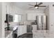 Bright kitchen features granite countertops, stainless steel appliances, and white cabinetry at 4313 E Briarwood Ter, Phoenix, AZ 85048