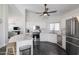 Bright kitchen with stainless steel appliances, white cabinetry, and a granite countertop island at 4313 E Briarwood Ter, Phoenix, AZ 85048