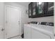 Functional laundry room with washer, dryer, and overhead storage, for efficient chores at 4313 E Briarwood Ter, Phoenix, AZ 85048