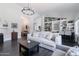 Open living room showcasing dark wood floors, stylish furniture, and a built-in bookshelf at 4313 E Briarwood Ter, Phoenix, AZ 85048
