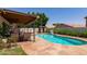 Beautiful backyard pool with covered patio, outdoor kitchen and mature landscaping at 4313 E Briarwood Ter, Phoenix, AZ 85048