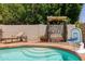Refreshing pool with lounge area, decorative pergola, and lush landscaping at 4313 E Briarwood Ter, Phoenix, AZ 85048