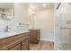 Bathroom featuring double sinks with marble countertops, framed mirrors and tiled walk-in shower at 4340 E Nisbet Rd, Phoenix, AZ 85032