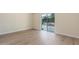 Bright bedroom featuring wood-look floors and sliding glass door to the backyard at 4340 E Nisbet Rd, Phoenix, AZ 85032