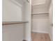 Walk-in closet with wooden rods for hanging clothes and overhead shelf at 4340 E Nisbet Rd, Phoenix, AZ 85032