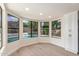 Bright dining area with large windows overlooking the pool and backyard, offering a serene view at 4340 E Nisbet Rd, Phoenix, AZ 85032