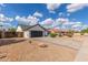 Charming single-story home features a two-car garage, gravel landscaping, and a beautiful blue sky backdrop at 4340 E Nisbet Rd, Phoenix, AZ 85032