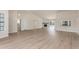 Open-concept living space with wood-look floors, fireplace, and ample natural light from the windows at 4340 E Nisbet Rd, Phoenix, AZ 85032