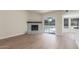 Comfortable living room with a fireplace and sliding doors that lead to the backyard and pool area at 4340 E Nisbet Rd, Phoenix, AZ 85032