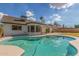 Inviting pool with white coping, seen from the manicured backyard, offers a refreshing escape at 4340 E Nisbet Rd, Phoenix, AZ 85032