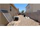 The gravel backyard features block fencing and outdoor equipment at 4432 W Pleasant Ln, Laveen, AZ 85339