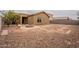 Desert-landscaped backyard features a custom fire pit and low-maintenance design at 4432 W Pleasant Ln, Laveen, AZ 85339