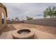 Backyard featuring desert landscaping, including a custom fire pit area at 4432 W Pleasant Ln, Laveen, AZ 85339