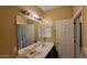 Bright bathroom featuring double sinks, medicine cabinet and vanity lights at 4432 W Pleasant Ln, Laveen, AZ 85339