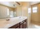 This bathroom features a double sink vanity and a large mirror at 4432 W Pleasant Ln, Laveen, AZ 85339