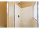 This bathroom includes a shower with white tile walls and shower head at 4432 W Pleasant Ln, Laveen, AZ 85339