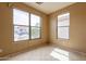 This bedroom features a large window for ample natural light, tile flooring, and neutral paint at 4432 W Pleasant Ln, Laveen, AZ 85339