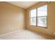 Neutral bedroom has tile floors, a window for natural light, and a fresh coat of paint at 4432 W Pleasant Ln, Laveen, AZ 85339