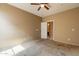 A bedroom with a ceiling fan and ensuite bathroom provides convenience at 4432 W Pleasant Ln, Laveen, AZ 85339