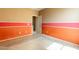 A bedroom featuring a vibrant orange and pink paint scheme at 4432 W Pleasant Ln, Laveen, AZ 85339