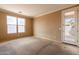 This bedroom features a large window and a glass door leading to the yard at 4432 W Pleasant Ln, Laveen, AZ 85339