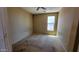 Bedroom with carpet flooring, ceiling fan, and a window for natural light at 4432 W Pleasant Ln, Laveen, AZ 85339