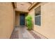 Entryway to home features a solid door with sidelight window and desert landscaping in view at 4432 W Pleasant Ln, Laveen, AZ 85339