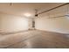 Two-car garage featuring concrete flooring and a hot water tank in the corner at 4432 W Pleasant Ln, Laveen, AZ 85339