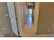 Hallway with neutral colors, light tile flooring, and doors leading to multiple rooms at 4432 W Pleasant Ln, Laveen, AZ 85339